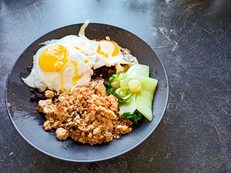 original image of stir-fried holy basil with two fried eggs and riceberry rice